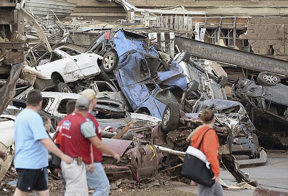 Damaged cars are seen in the parking lot of a Moore hospital