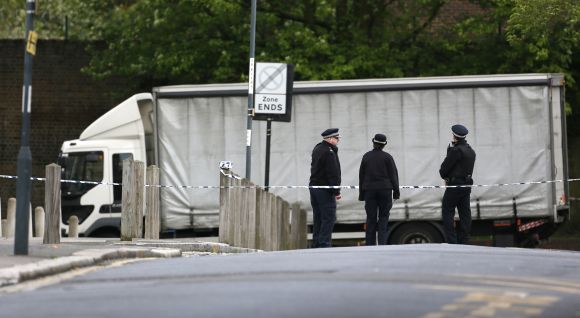 Police officers guard a cordon set up around a crime scene where one man was killed in Woolwich