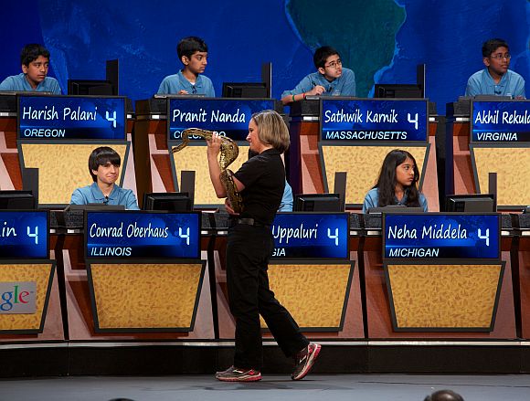 Amy Eveleth of the Baltimore Zoo displays boa constrictor Humphrey Bogart to the top 10 National Geographic Bee finalists during a round of the competition