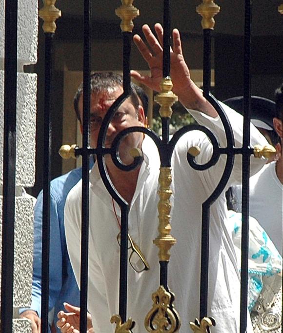 Actor Sanjay Dutt waves to the media outside his Bandra residence before he surrendered on May 16