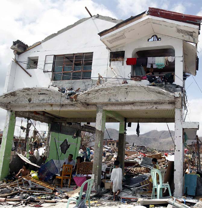 Survivors stay in their damaged house after super Typhoon Haiyan battered Tacloban city, central Philippines