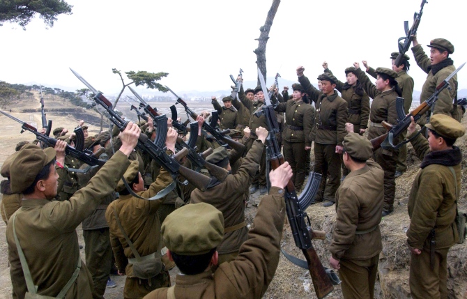 Members of the Worker-Peasant Red Guards, the civilian forces of North Korea, shout slogans in an undisclosed location in this picture released by KCNA in Pyongyang.