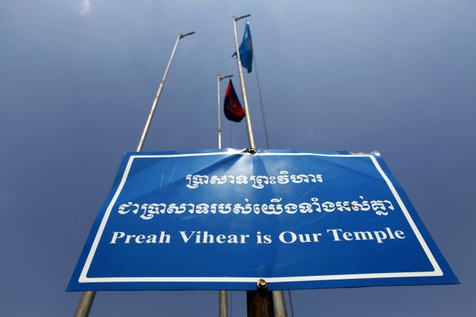 A sign is seen under Cambodian and UNESCO flags at the Preah Vihear temple