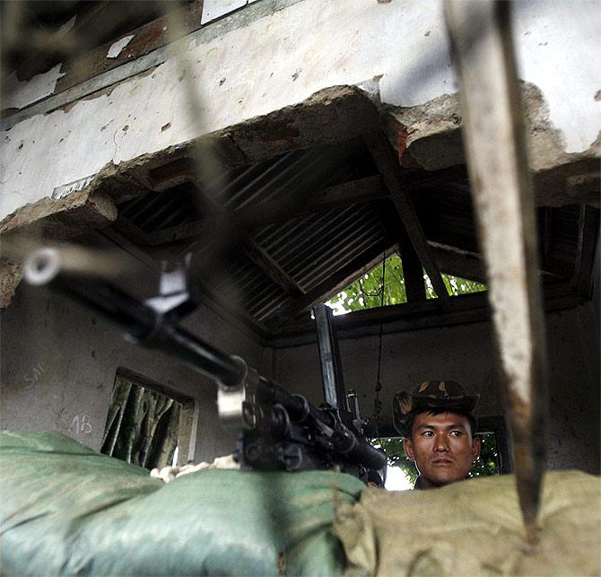 A soldier of the Indian army stands guard in his bunker in Bordumsa village on the road to India-China border in Arunachal Pradesh