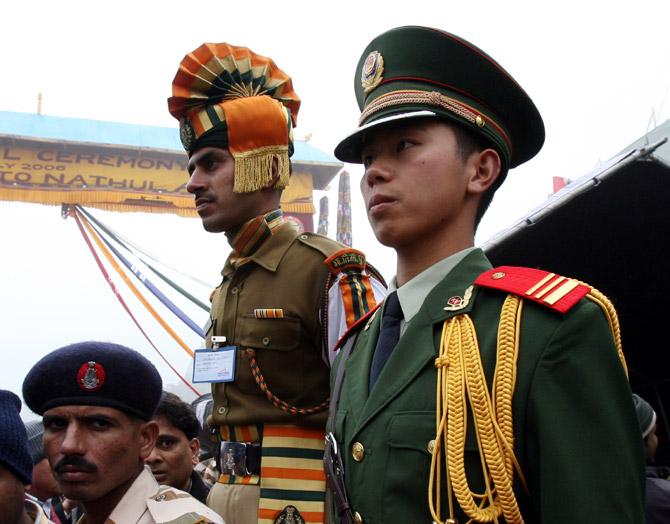 Chinese and Indian border guards stand at the Nathu La mountain pass, between Sikkim and Tiber