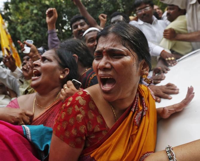 Supports of Telugu Desam Party chief Chandrababu Naidu, who has opposed the division of Andhra, shout slogans in New Delhi