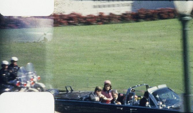 Frame 262 from Abraham Zapruder's 8mm film of JFK's assassination, Dallas, Texas, Nov. 22, 1963. President Kennedy's arms are raised, in a locked position, in front of him, after the first bullet has struck.