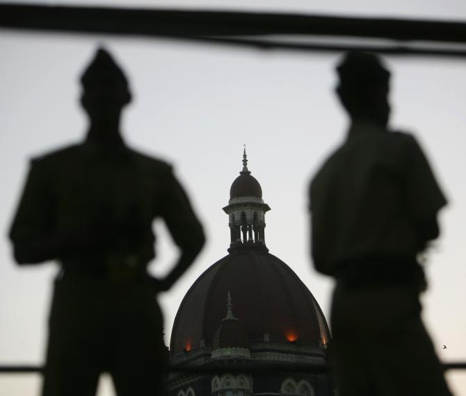 Policemen stand guard outside the Taj Mahal hotel, one of the sites of the 26/11 attacks in Mumbai.