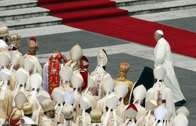 Pope Francis walks away at the end of a mass to prepare an urn containing the relics of the Apostle St. Peter for public veneration, at the Vatican