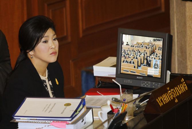 Thailand's Prime Minister Yingluck Shinawatra listens to a debate by the opposition in parliament in Bangkok 