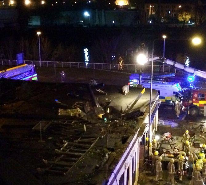 Remains of the helicopter are seen on the roof of the pub