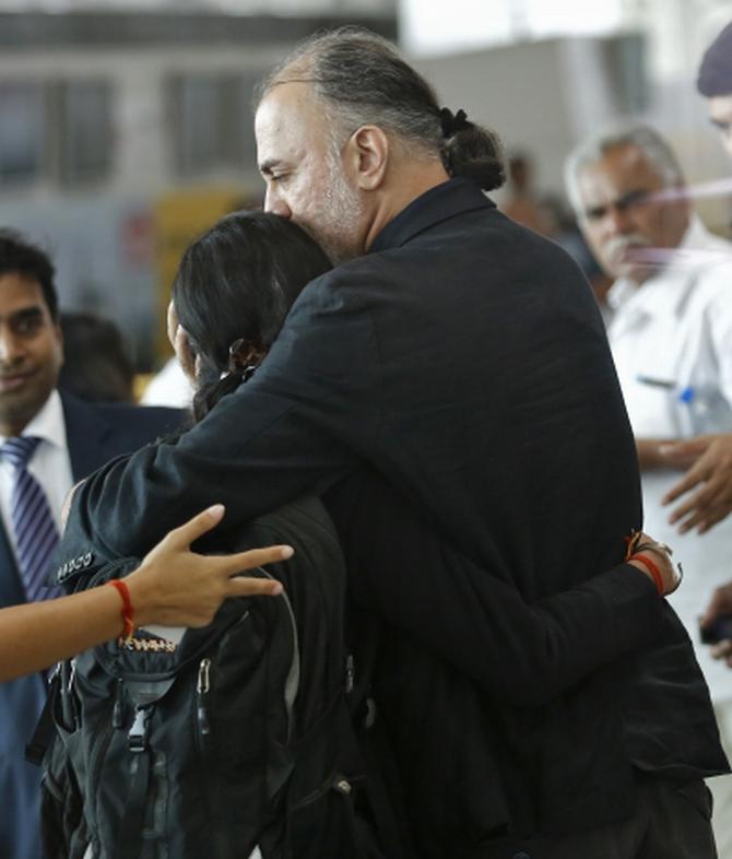 Tarun Tejpal hugs an unidentified relative at the airport on his way to Goa