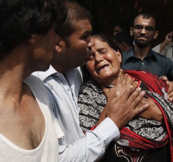 A Christian woman mourns the death of her son at the site of a suicide blast at a church in Peshawar