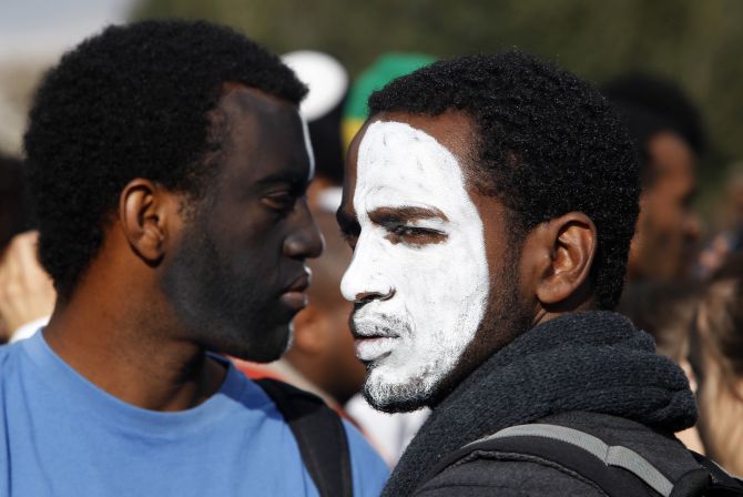 Protesters with their faces painted attend a demonstration in protest of the discrimination against Israelis of Ethiopian descent, in Jerusalem