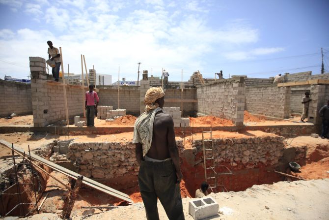 Labourers work at a petrol station construction site in Mogadishu
