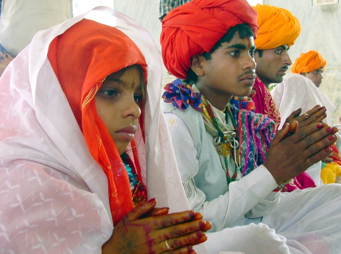 Sheela, 8, sits besides her 14-year-old groom Daulat Ram during their marriage ceremony