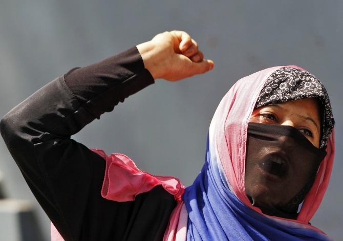  A veiled Kashmiri Muslim woman shouts slogans during a protest rally in Srinagar 