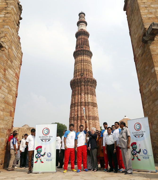 Indian hockey player Dharamvir Singh holds the Commonwealth Games Baton which arrived in India before the Commonwealth Games in Glasgow in 2014.