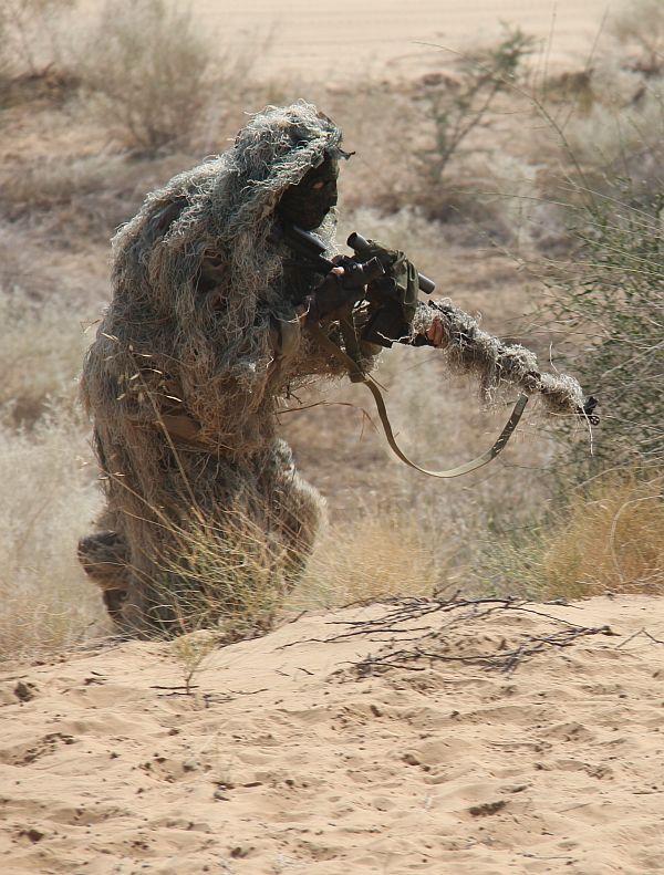 An Indian Army Special Forces soldier takes up a position during a drill