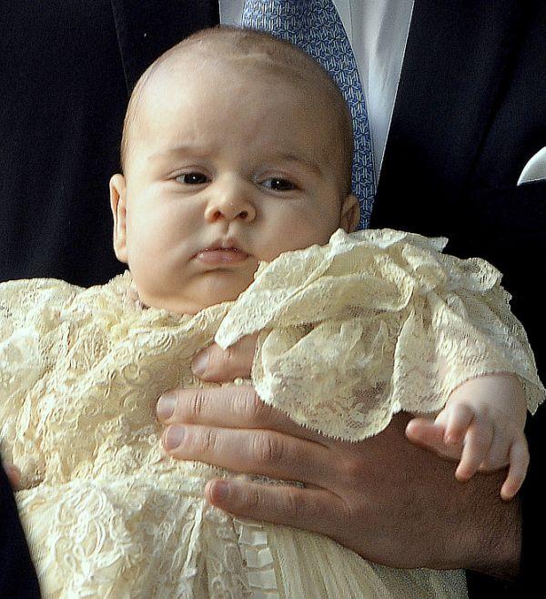 Britain's Prince William carries his son Prince George as they arrive for his son's christening at St James's Palace in London