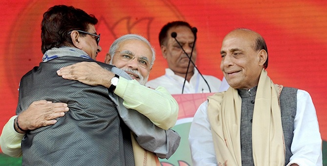 Modi hugs Shatrughan Sinha as BJP chief Rajnath Singh watches on 