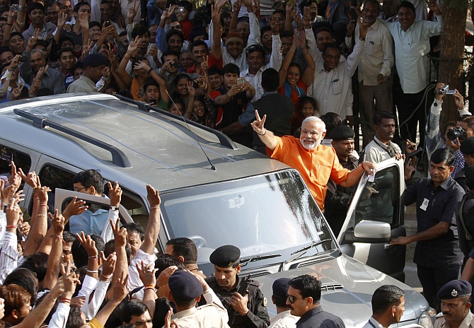 Gujarat state Chief Minister Narendra Modi gestures as he arrives to cast his vote during the second phase of state elections in Ahmedabad