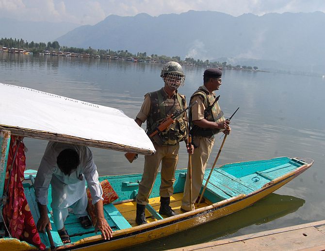 Security personnel on a shikara on Dal Lake