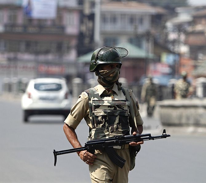 A policeman patrols a street during a strike called by separatists against the concert by the Bavarian State Orchestra and renowned conductor Zubin Mehta, in Srinagar