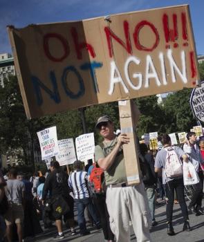 Anti-war activists hold placards after marching to Union Square in Manhattan, New York