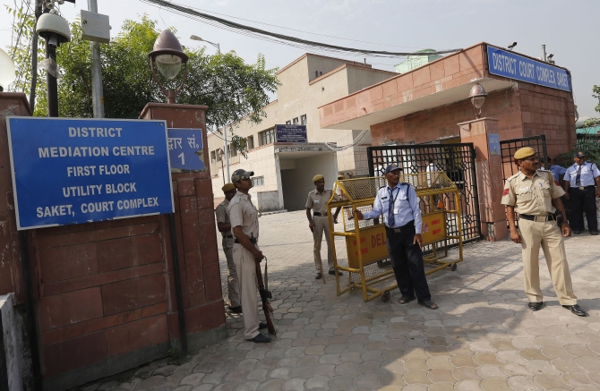 Policemen stand guard outside the Saket court in New Delhi where the gang-rape case verdict was delivered on Tuesday