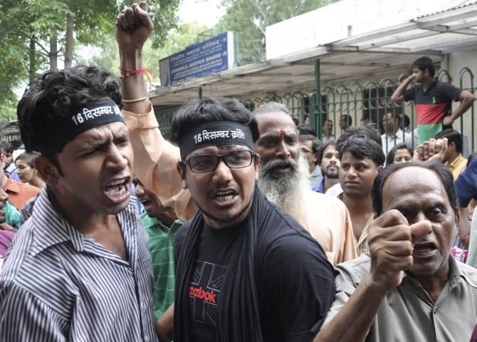 Demonstrators shout slogans outside the juvenile court in New Delhi against the sentencing of the minor convict in the Delhi gang-rape case