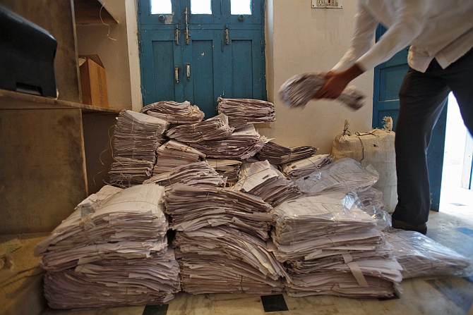 An operator arranges the Unique Identification documents submitted by people