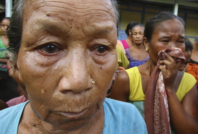 Women affected by the ethnic riots in Assam cry at a relief camp at Goshaigaon town in July, 2012.