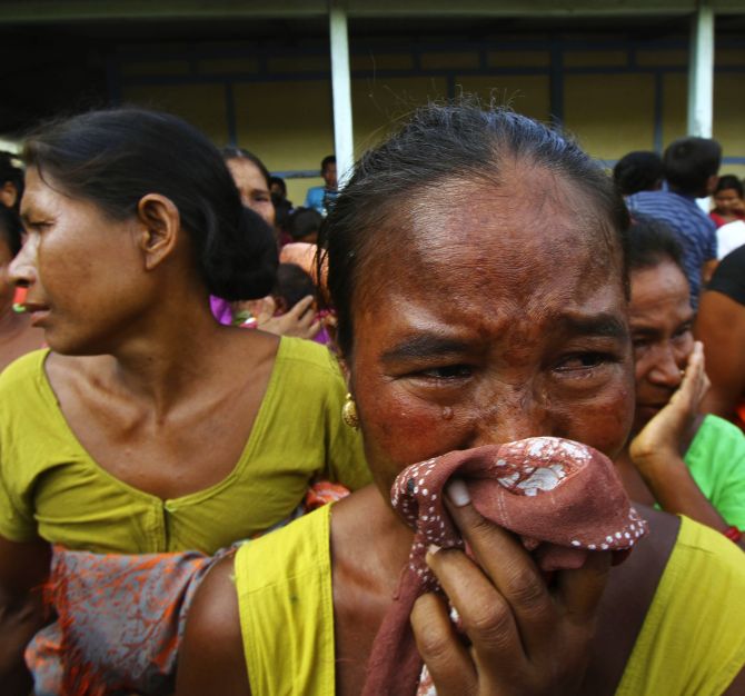 A woman affected by ethnic riots in Assam in 2012 cries after her house was burnt during violence, at a relief camp at Goshaigaon town.