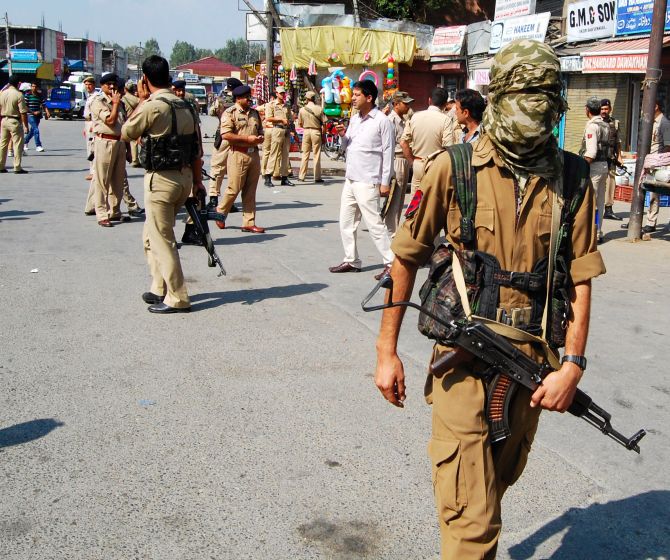 CISF and J&K Police personnel cordon of the site of a militant strike in Srinagar on Monday