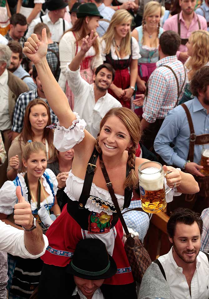 Revellers reach for the first beer mug at Hofbraeuhaus beer tent during day 1 of the Oktoberfest 2013 beer festival at Theresienwiese on September 21, 2013 in Munich, Germany. The Munich Oktoberfest, which this year will run from September 21 through October 6, is the world's largest beer fest and draws millions of visitors.