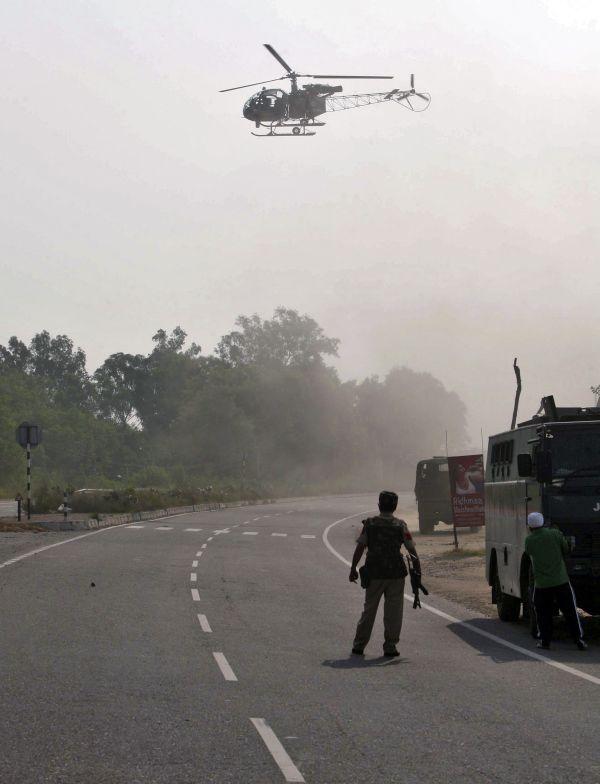 An army helicopter hovers near an army camp during a gun battle in Samba district on Thursday.