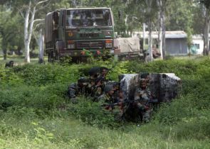 Indian Army soldiers take up position near an army camp during a gun battle in Mesar in Samba district on Thursday