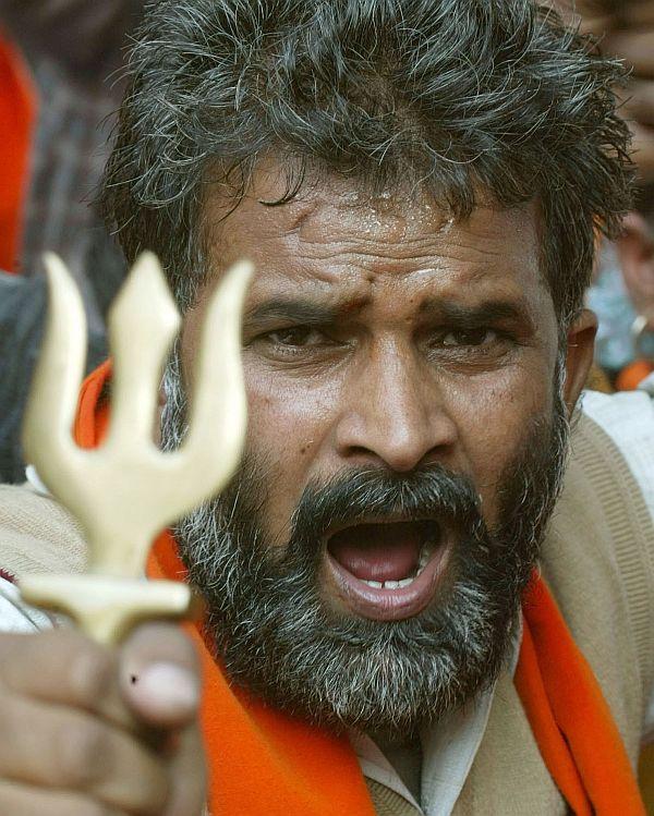 A Hindu activist brandshes a small trident during a demonstration