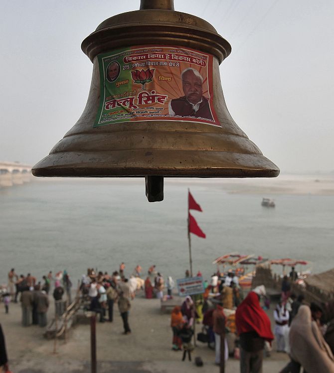 A temple bell pasted with a pamphlet of Bharatiya Janata Party is seen on the banks of the river Saryu at Ayodhya
