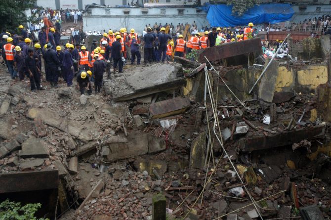 Firefighters and rescue workers at the site of building collapse