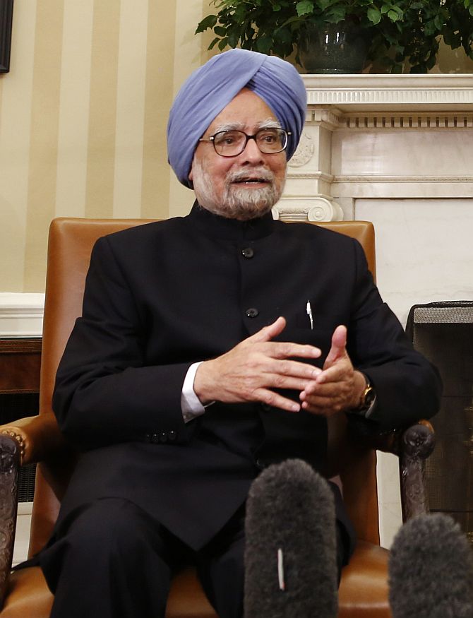 Prime Minister Manmohan Singh speaks as US President Barack Obama looks on, during their meeting in the Oval Office of the White House in Washington