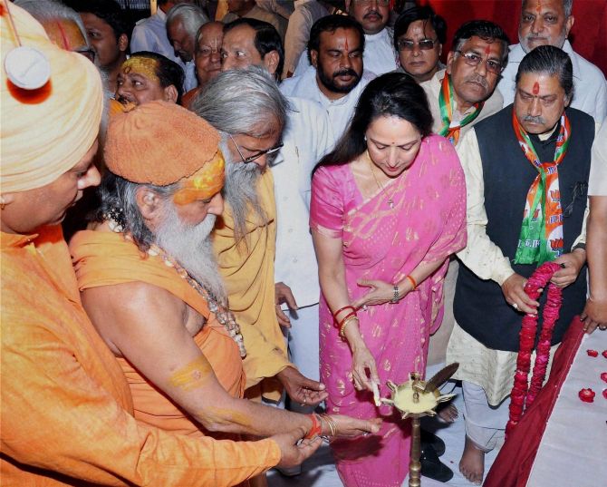 BJP Candidate and Bollywood actress Hema Malini lighting lamp along with priests during her election campaign in Mathura on Monday