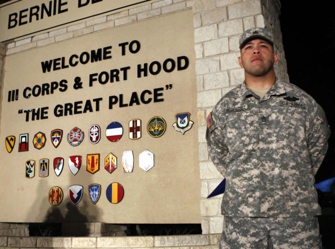 Sgt First Class Erick Rodriguez stands guard before a news conference by Lt Gen Mark Milley at the entrance to Fort Hood Army Post in Texas