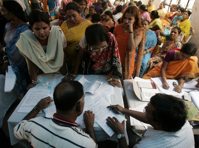 Sex workers submit their forms during a voters' enrolment camp in Sonagachi, the largest red light district of Kolkata.