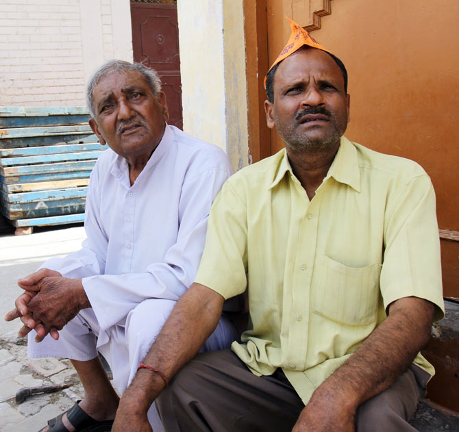 Mahavir Singh sits in a lane near his home in Arthala. He has seen many factories close down in his lifetime.