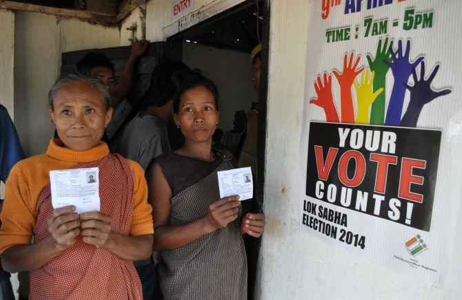 Voters flash their ID cards before casting their ballot in Meghalaya on Wednesday