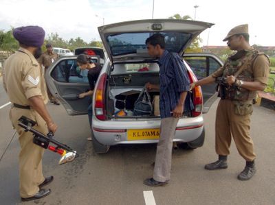 Policemen search a car at a checkpoint outside an airport in Kerala. Photograph: Dipak/Reuters. Photograph published for representational purposes only.