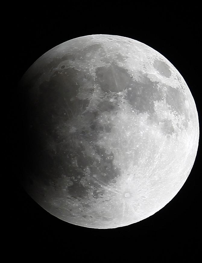 A shadow falls on the moon as it undergoes a total lunar eclipse as seen from Mexico City