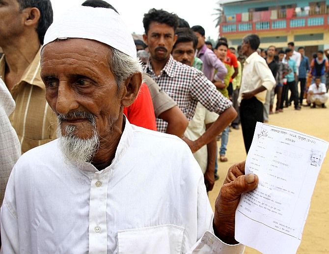 A Muslim voter waits to cast his vote during an election